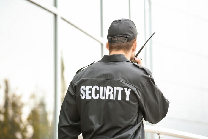 Courthouse security personnel monitoring the entrance with advanced surveillance equipment.