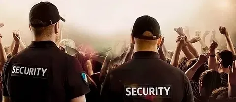 rained security personnel managing crowd control at a festival.