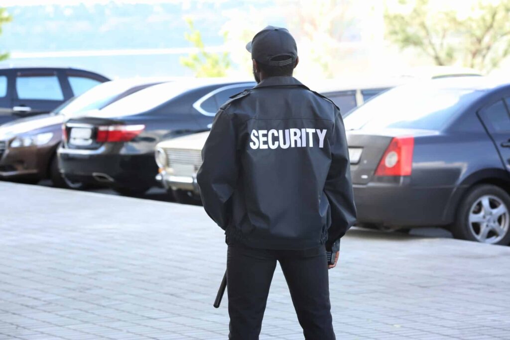 Trained parking lot security personnel providing protection with access control and surveillance systems.