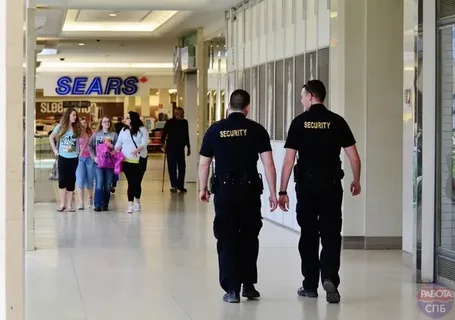 Shopping mall security guards patrolling a plaza to ensure safety.