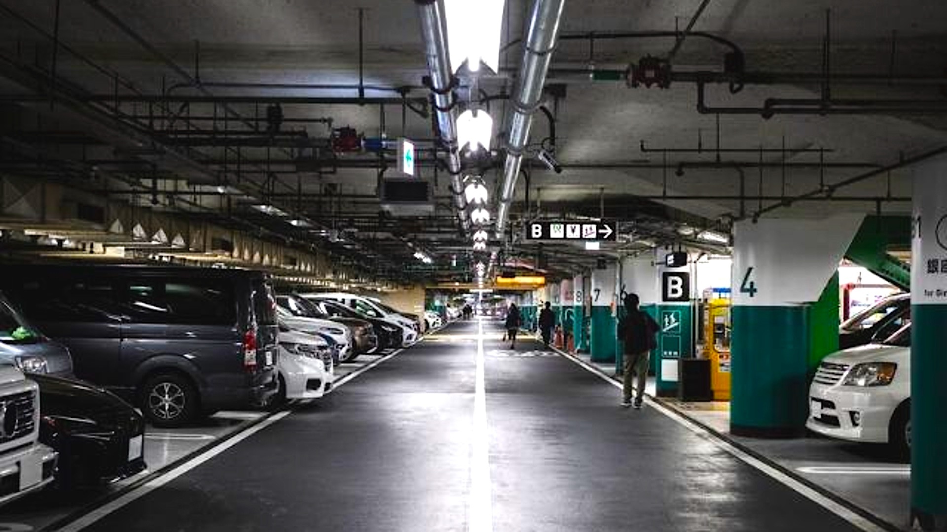 Parking lot security guard monitoring with surveillance cameras to protect vehicles and premises.