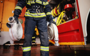 Close up view of a firefighter with hoses